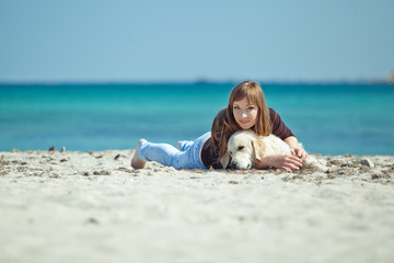 Woman with dog on the beach 