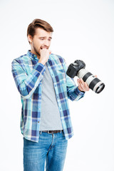 Stressed male photographer holding photo camera