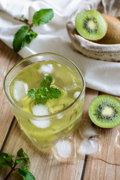 glass of refreshing tropical kiwi soda with mint