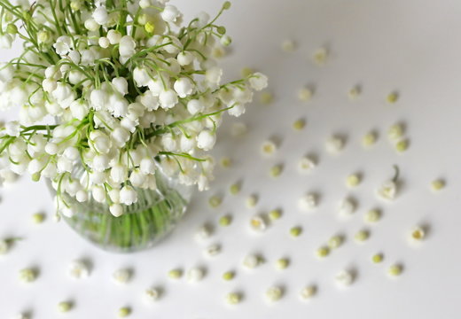 Spring bouquet of lily of the valley flowers in a vase. Photo from above.