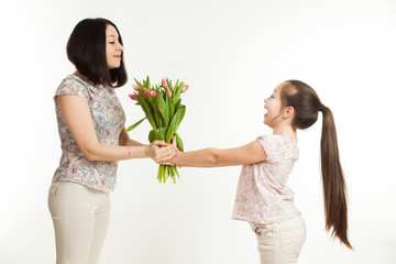 the girl gives to mother a bouquet