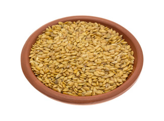 Bowl of organic golden flaxseed on a white background