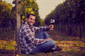 Winemaker siting in vineyard