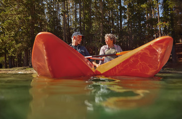 Senior couple kayaking in a lake