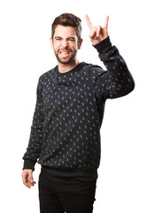 Fototapeta premium young man doing a rock symbol