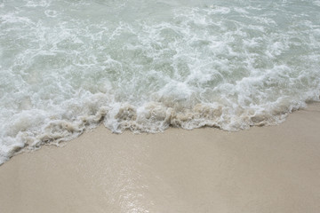 Fototapeta na wymiar Closeup rippled wave at the tropical beach