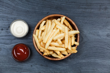 French fries closeup over wood background
