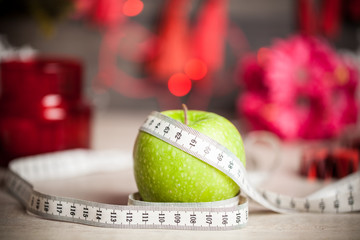 Green Apple with a measuring meter and Christmas decorations