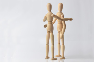 two wooden puppets