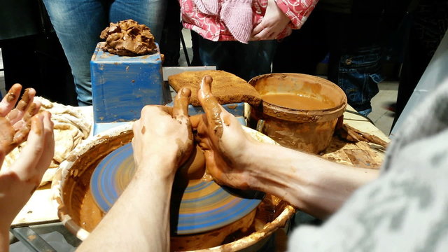 Hand of potter making clay pot
