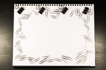 Notebook covered with silver clips and pen, idea concept, business concept.