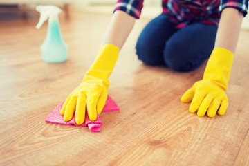 close up of woman with rag cleaning floor at home