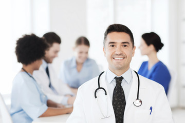 Fototapeta premium happy doctor over group of medics at hospital