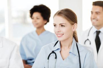 Fototapeta premium happy doctor over group of medics at hospital