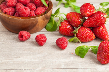strawberries and raspberries in bowls, top view, close-up Selective focus