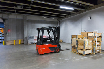 forklift loader and boxes at warehouse