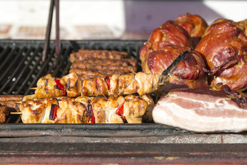 Different kind on grilled meat and sausages with smoke and steam from the grill