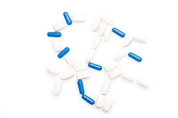 White and blue medical pills for treating diseases on a white background