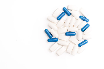 White and blue medical pills for treating diseases on a white background