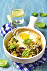 Pasta baked with spinach pesto,egg,mozzarella and mushrooms in a