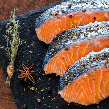 Raw Salmon portions seasoned with fine herbs.