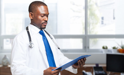 Black doctor portrait reading some documents