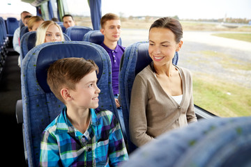 happy family riding in travel bus