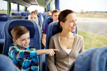 happy family riding in travel bus