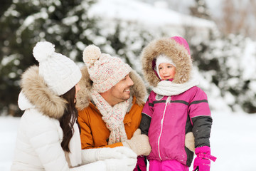 Fototapeta na wymiar happy family with child in winter clothes outdoors