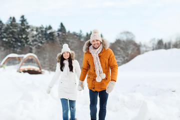 Fototapeta na wymiar happy couple walking over winter background