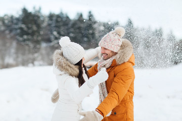 happy couple hugging and laughing in winter