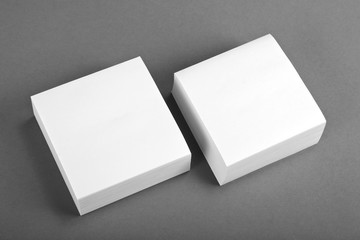 Collection of white note papers on gray background.