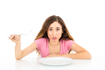 Woman on diet with an empty plate