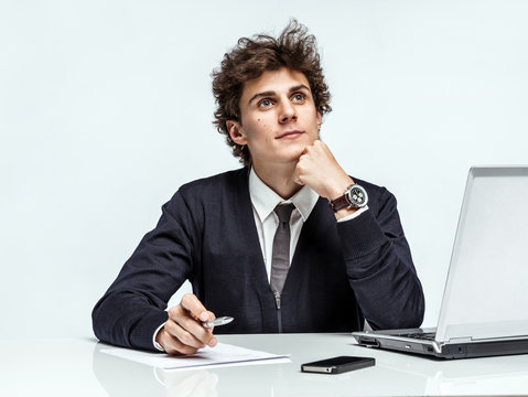 Young Businessman dream about his earnings, gain, benefit, margin / modern businessman at the workplace working with computer, depression and crisis concept
