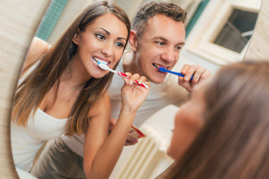 Couple Brushing Teeth