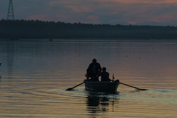 Fishing boat on the lake in the night