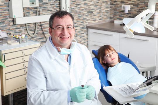 Male dentist and young patient