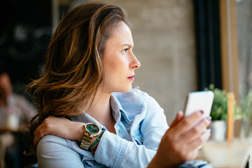 Philosophical looking girl holding mobile