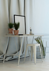 Simple writing table in front of long drapes