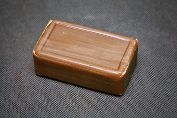 tar soap brown color on a dark background