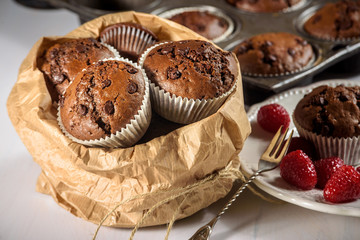 Chocolate muffins with red juicy raspberries