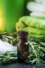 Rosemary essential oil Spa composition with sea salt, candles, t