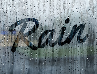 Rain written on a foggy window - 102846676