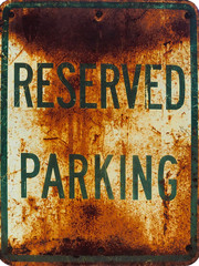 Rusty old "Reserved Parking" sign isolated 