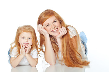 Mother with daughter in studio, white background 