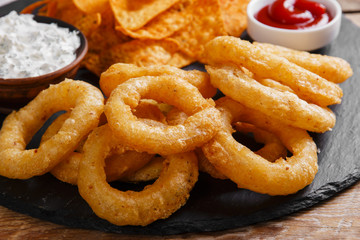 fried onion rings in batter with sauce tortilla chips