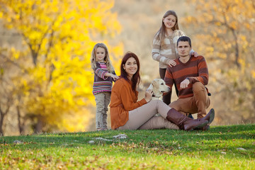 Fototapeta premium Happy family on nature with a labrador