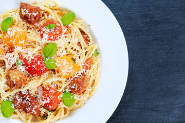 Sausage Pasta spaghetti with summer vegetables, background
