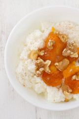 cottage cheese with pumpkin jam and nuts in bowl