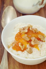 fresh cheese with pumpkin jam and nuts in white bowl